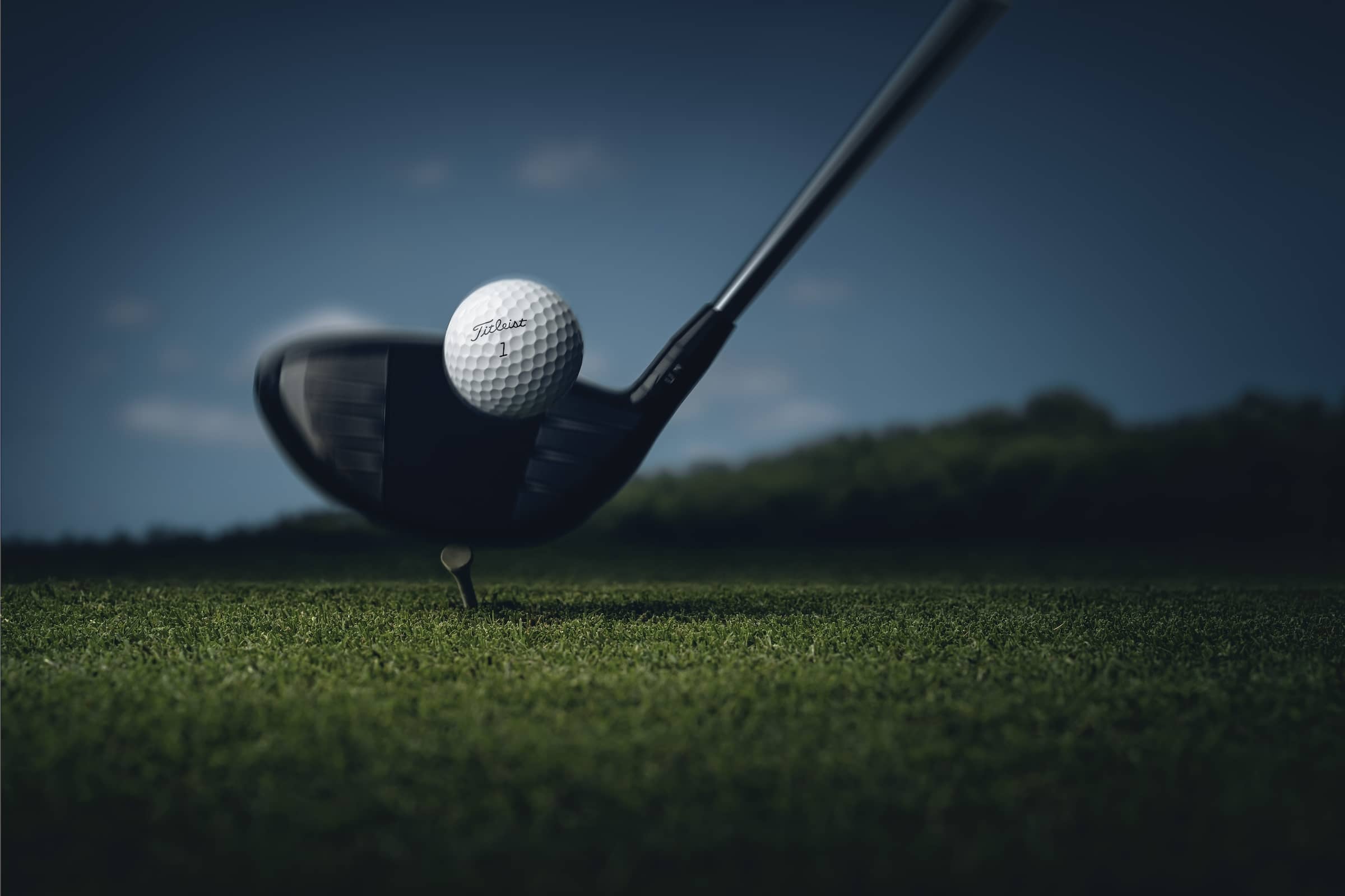Titleist Golf ball about to be hit by a Driver