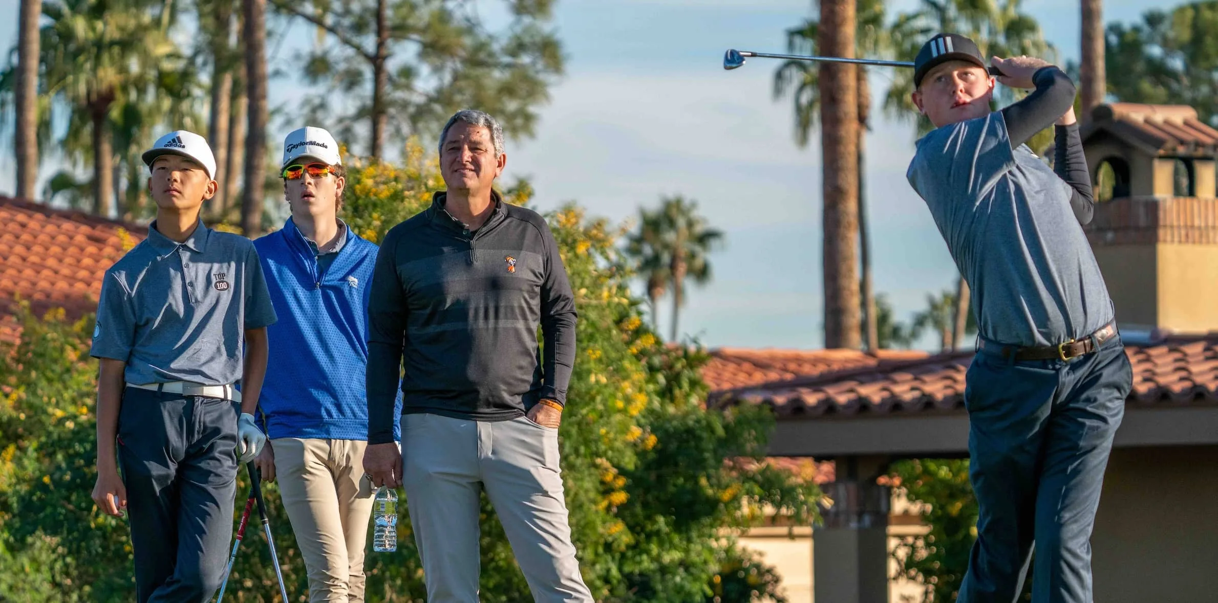Young-Golfers-watch-fellow-young-golfer-tee-off