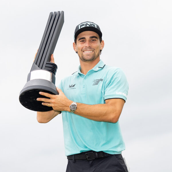 Joaquín Niemann of Torque GC celebrates with caddie, Gary Matthews, on stage during the trophy ceremony after the final round of LIV Golf Virginia at RTJ