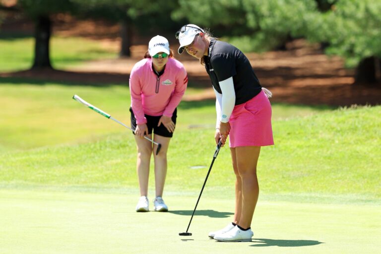 Jennifer Kupcho of the United States (R) and Leona Maguire of Ireland line up a putt on the fifth hole during the second round of the Dow Championship 2025 at Midland Country Club