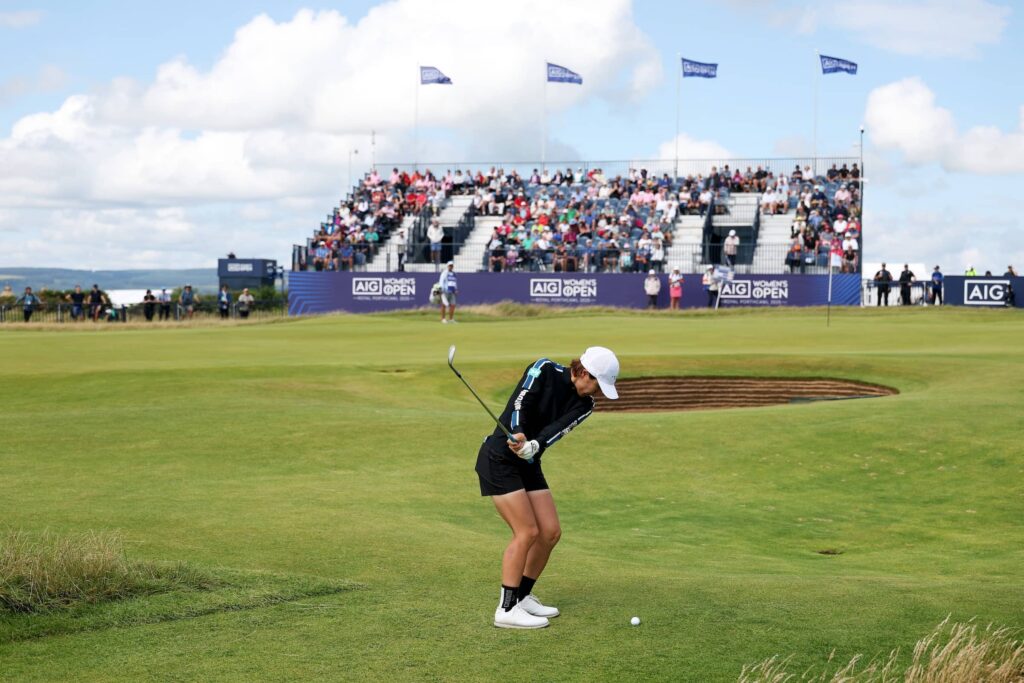 Eri Okayama of Japan pitches onto the 18th green during the first round of the AIG Women's Open 2025