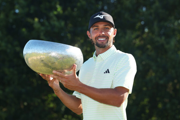 Marco Penge of England poses for a photo holding the trophy on the 18th hole after winning the Danish Golf Championship 2025 at Furesø Golfklub Birkerod, Denmark.