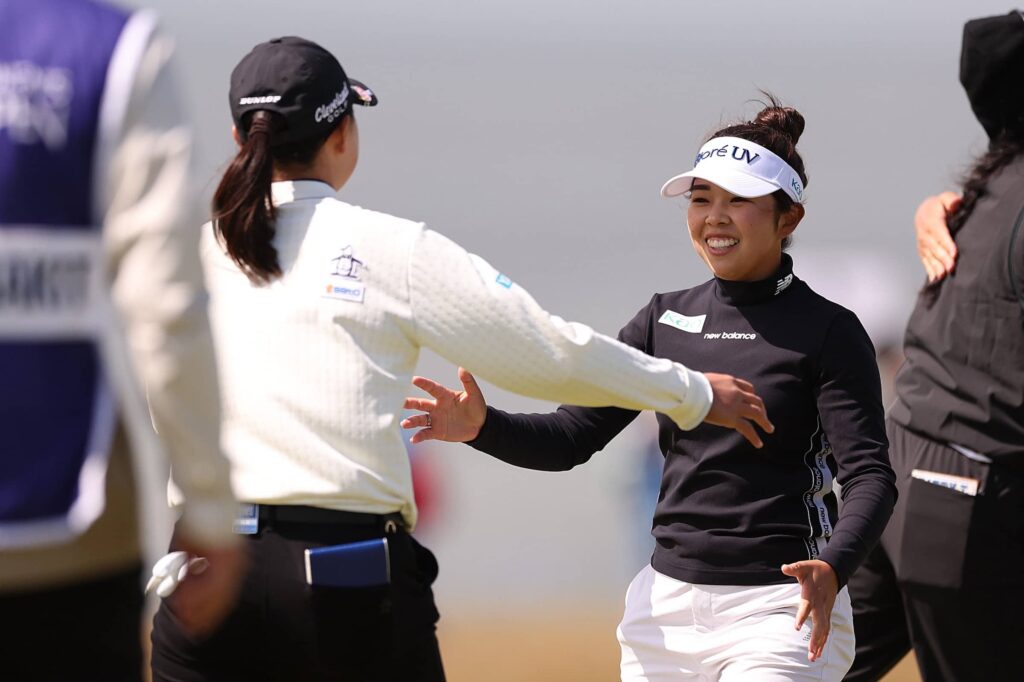 Rio Takeda of Japan and Miyu Yamashita of Japan embrace on the 18th green during the second round of the AIG Women's Open 2025 at Royal Porthcawl Golf Club