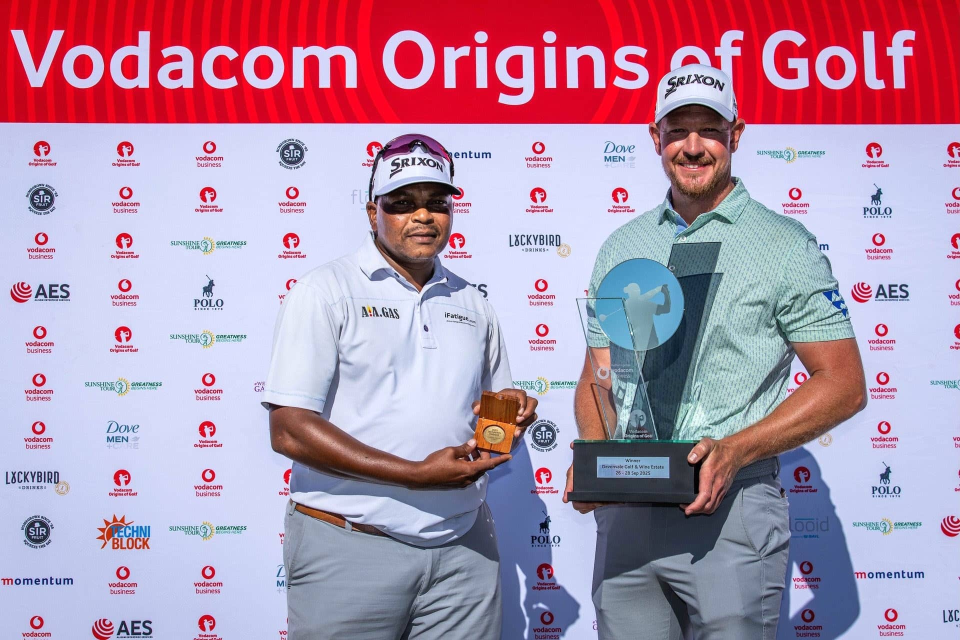 Jacques Kruyswijk (right) and his caddie, Terence Mngoma. Mngoma received a Sunshine Tour medallion for the winning caddie.