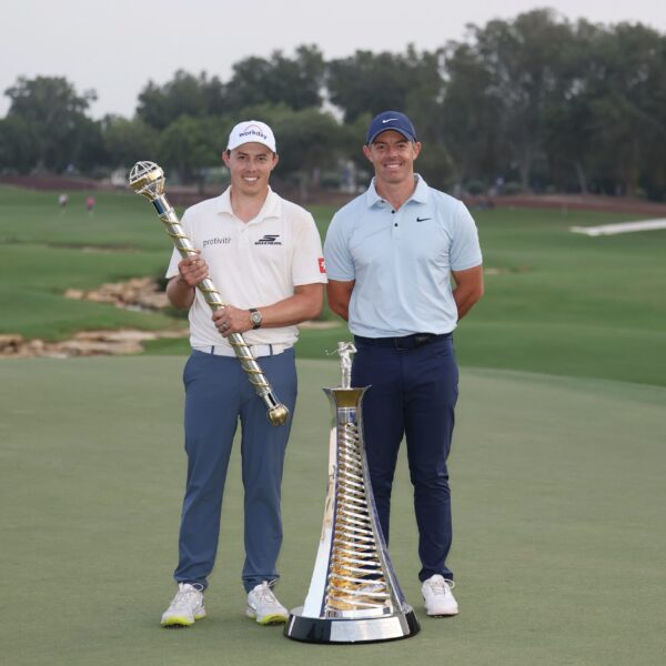 Matt Fitzpatrick of England and Rory McIlroy of Northern Ireland pose on the 18th green with the DP World Tour Championship and Race to Dubai trophies on day four of the DP World Tour Championship 2025 at Jumeirah Golf Estates