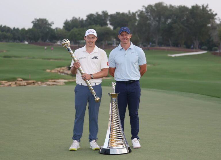 Matt Fitzpatrick of England and Rory McIlroy of Northern Ireland pose on the 18th green with the DP World Tour Championship and Race to Dubai trophies on day four of the DP World Tour Championship 2025 at Jumeirah Golf Estates