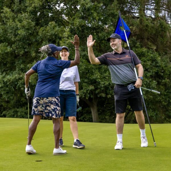 Amateur Golfers high five on the green