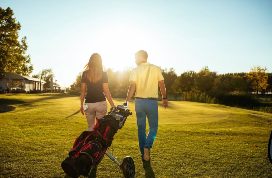 Golfing couple walk together