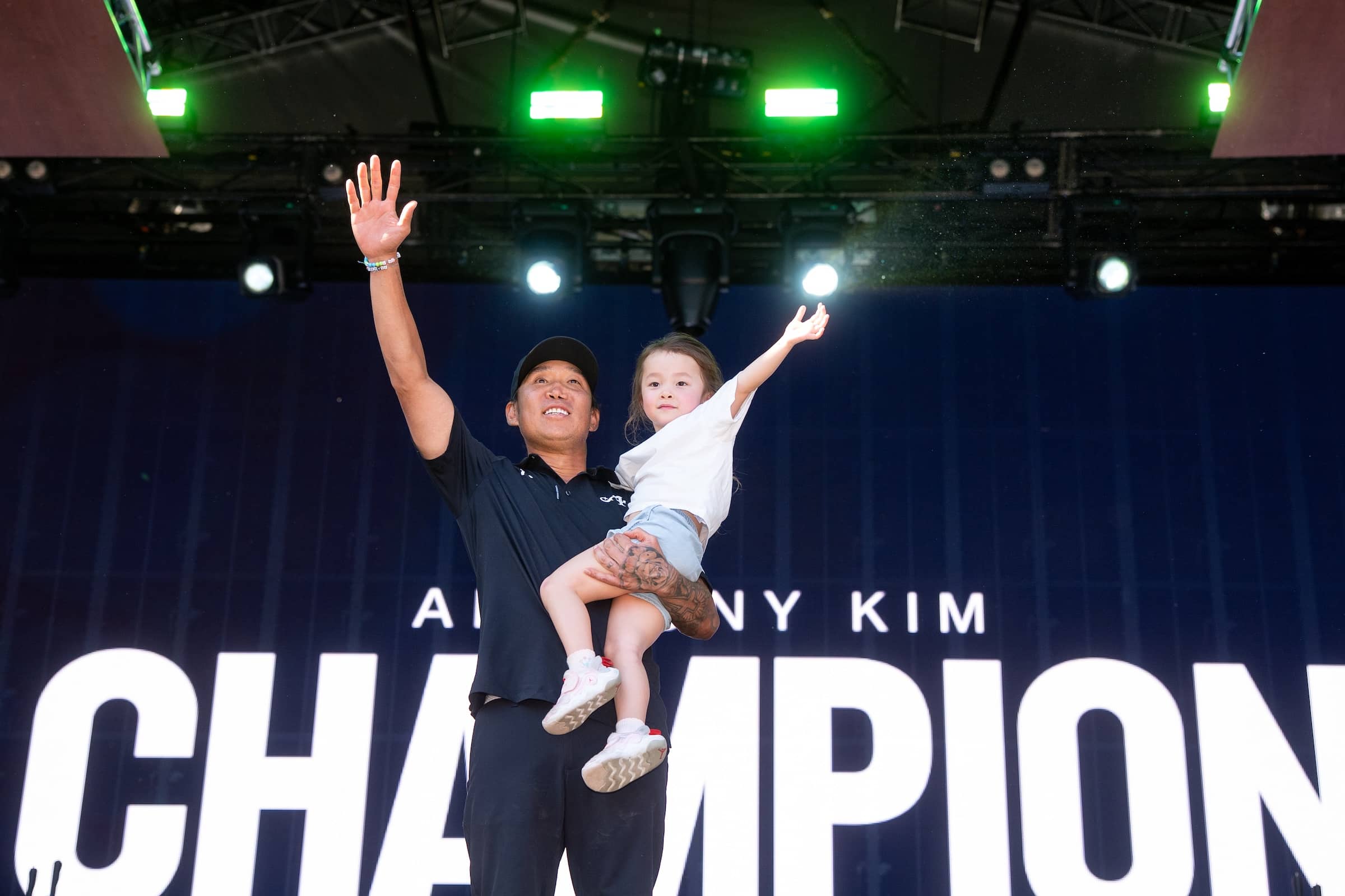 First place individual champion, Anthony Kim of 4Aces GC celebrates with his daughter Bella during the trophy ceremony after the final round of the LIV Golf Adelaide at Grange Golf Club