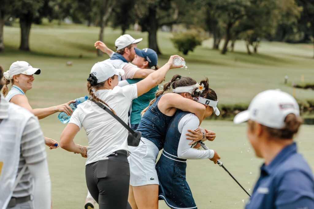 Lois Lau celebrates on the green