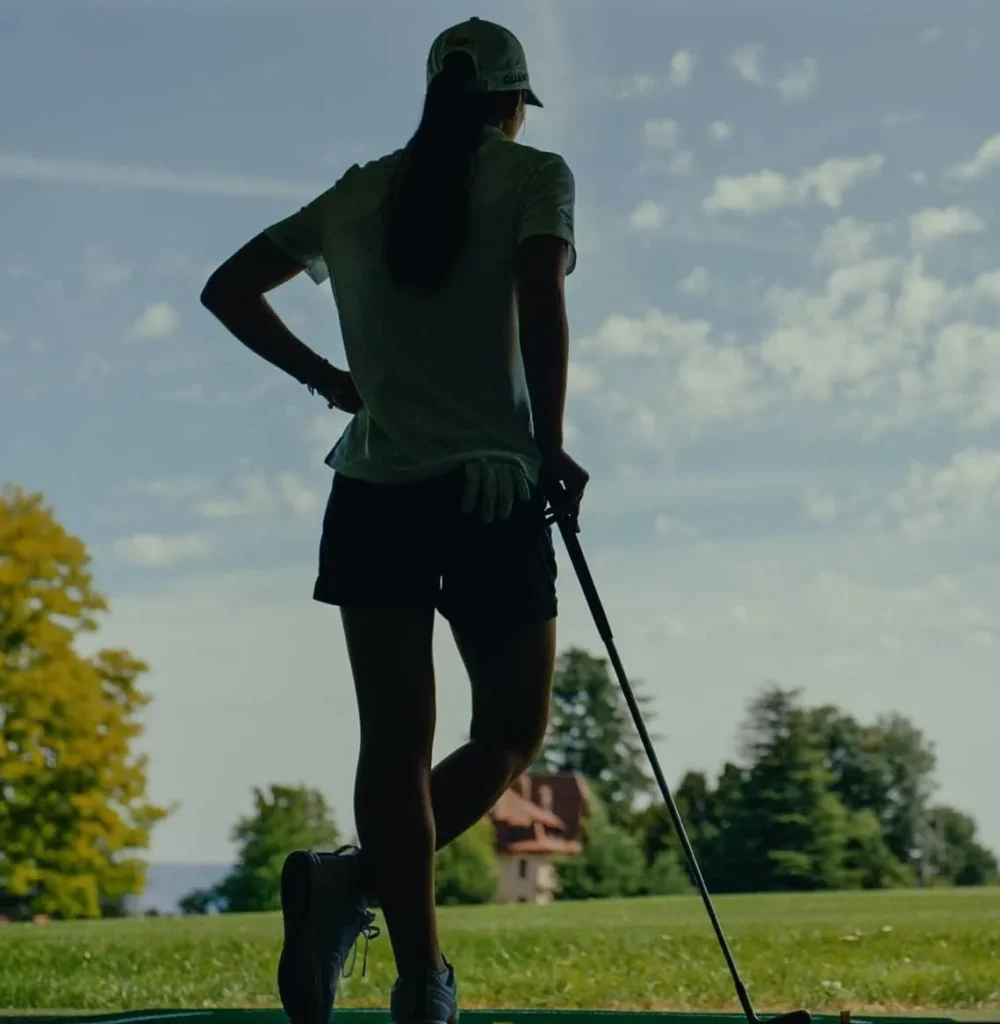 Female golfer in the shadows