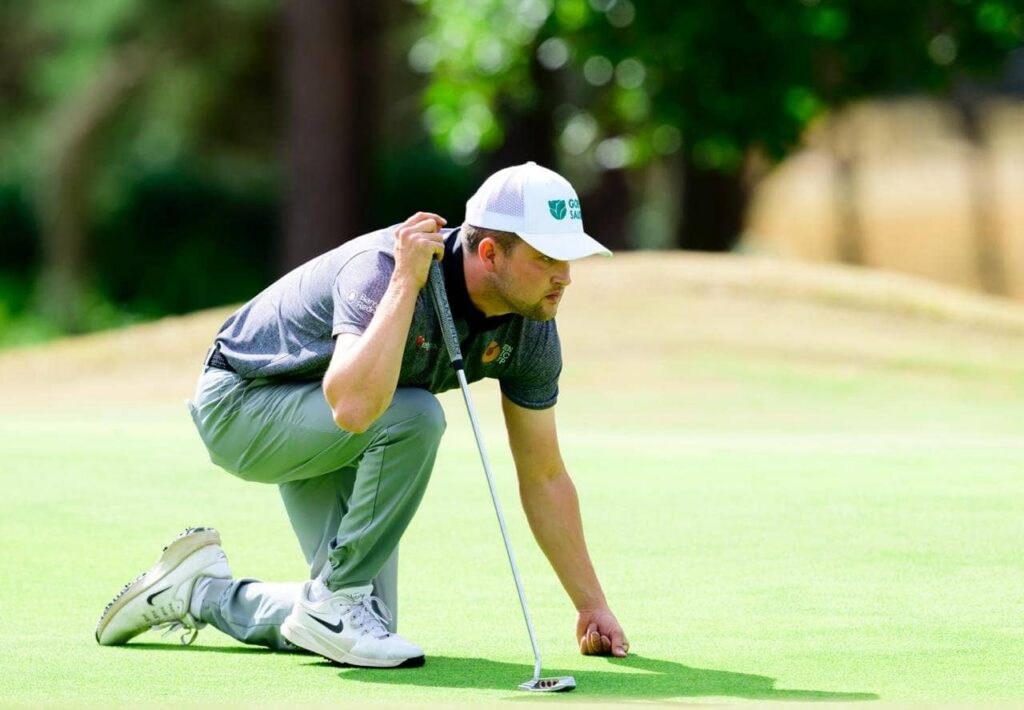 Kipp Popert lines up his putt on the green