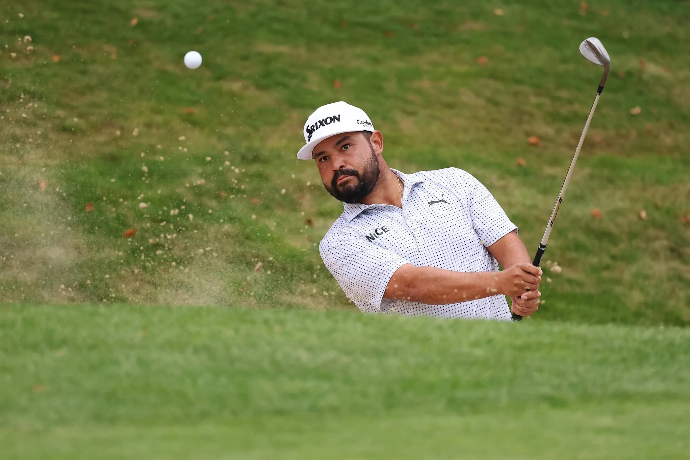 JJ Spaun hits his shot out of the bunker