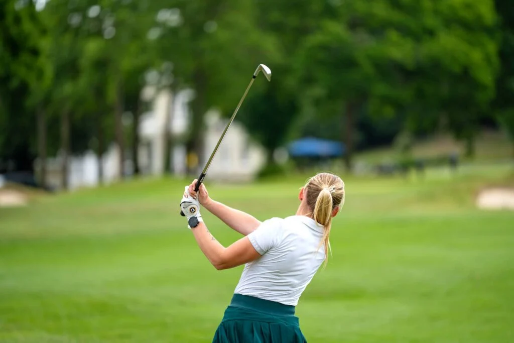 Woman hits Golf Ball from Fairway Shot Scope